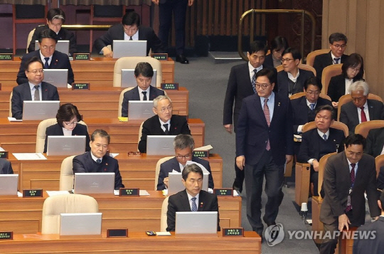 우원식 국회의장이 9일 오후 국회 본회의장에 들어서며 최상목 대통령 권한대행의 빈 자리를 바라보고 있다.[연합뉴스]